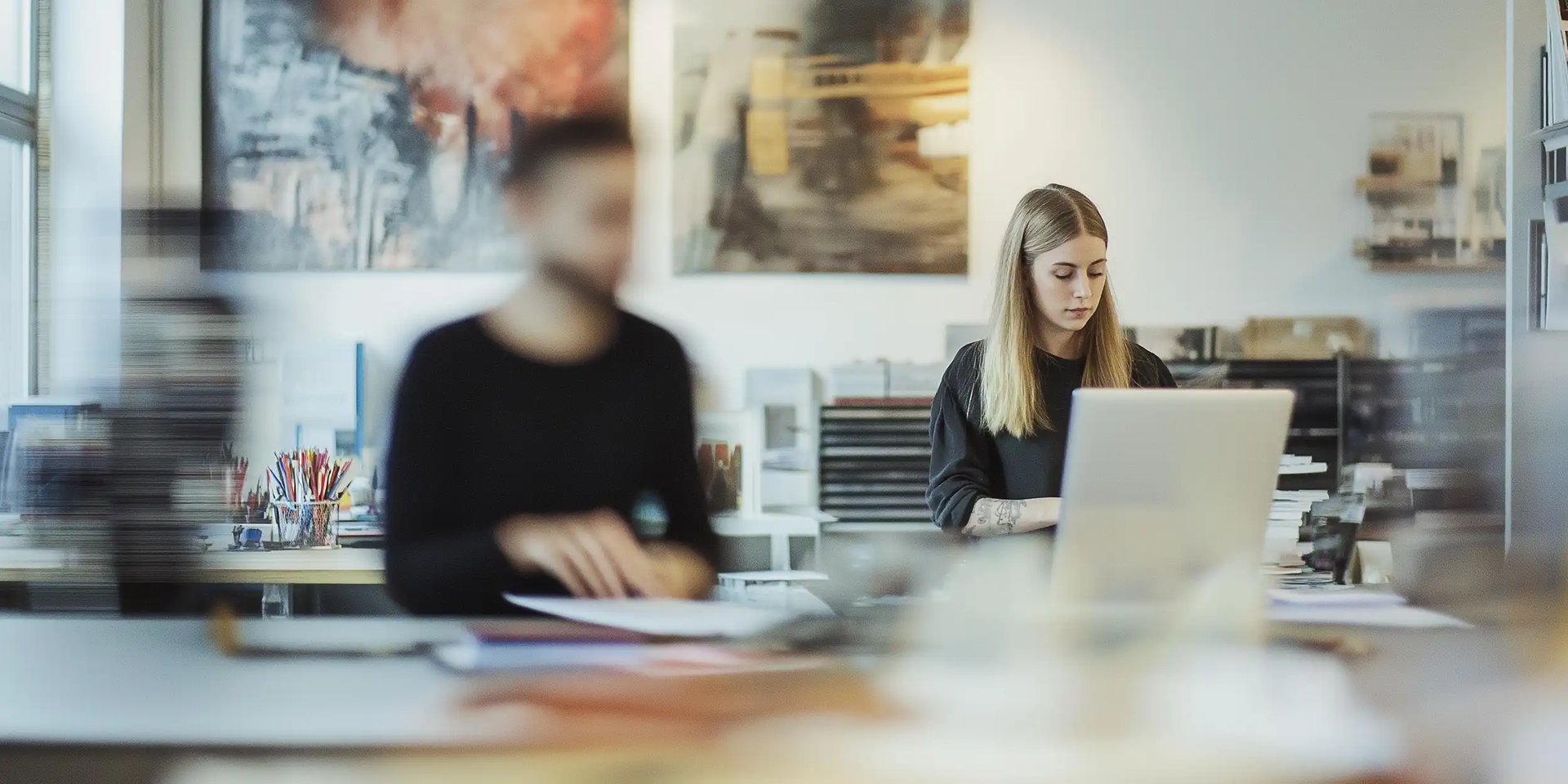 A manager using her Ipad to communicate with employees