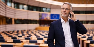 A man speaking on the phone in the European parliament