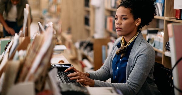 Woman working on her AI workforce management in a book store