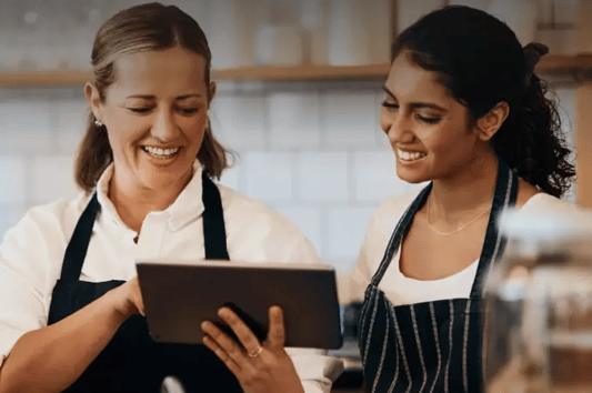 Faster onboarding and execution, employees looking at tablet together