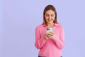 person-in-pink-checking-phone-pruple